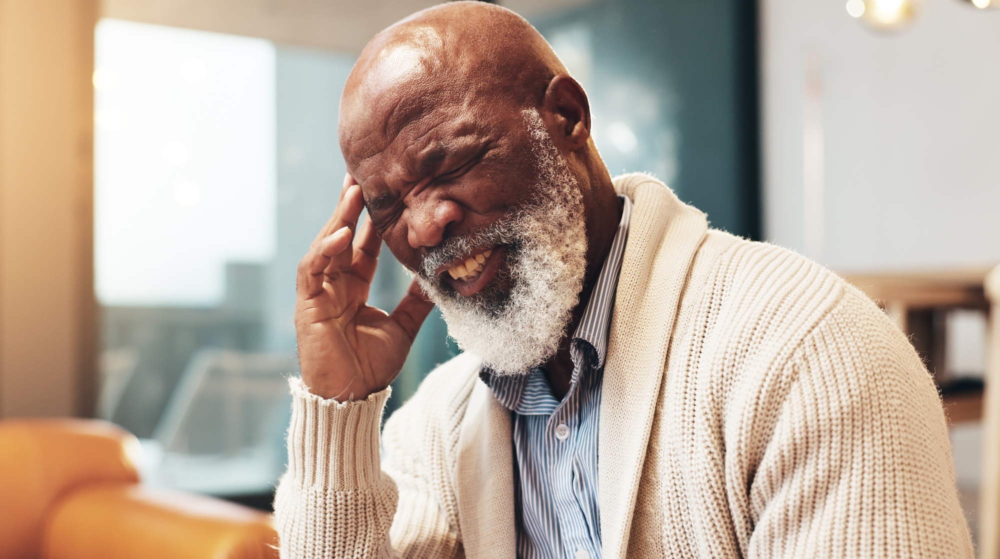 Home, senior and black man with pain for headache, muscle tension and emergency for hypertension. H